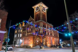 Historic building in downtown New Bern decorated with holiday lights at night